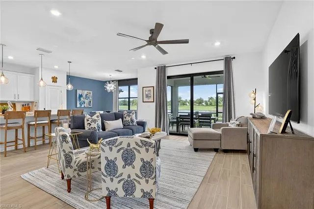 a living room with furniture large window and a flat screen tv