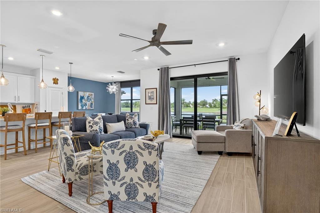 1657 Serena Avenue Naples, FL 34120 - Photo 4 of 40 a living room with furniture large window and a flat screen tv
