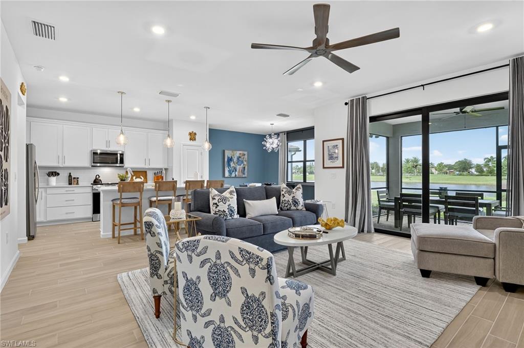 1657 Serena Avenue Naples, FL 34120 - Photo 5 of 40 a living room with furniture and a large window with outer view