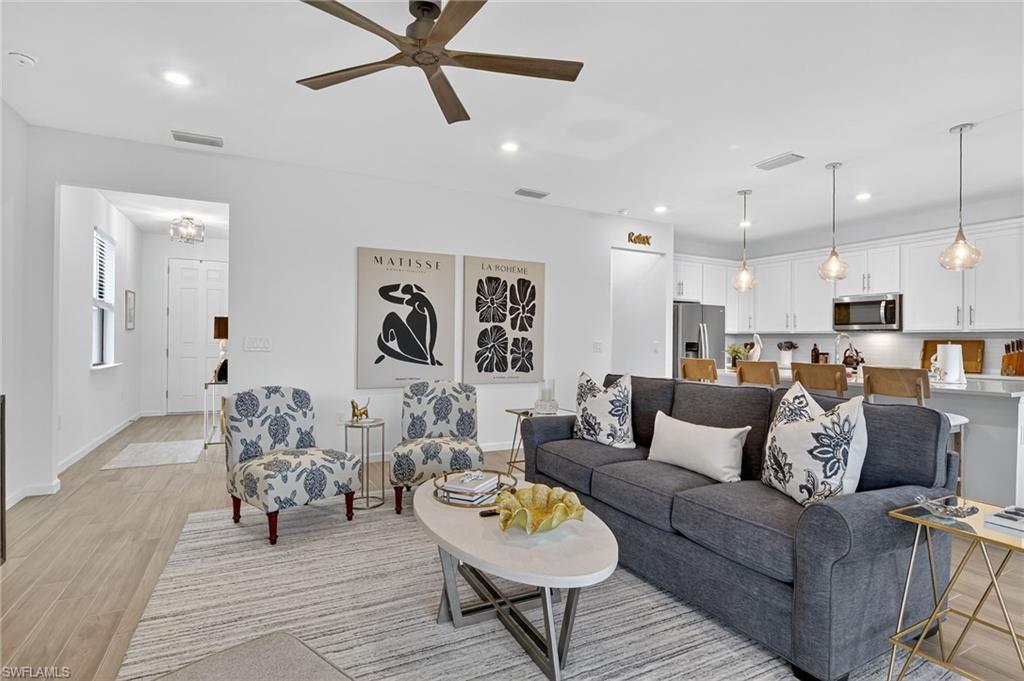 1657 Serena Avenue Naples, FL 34120 - Photo 39 of 40 a living room with furniture and kitchen view