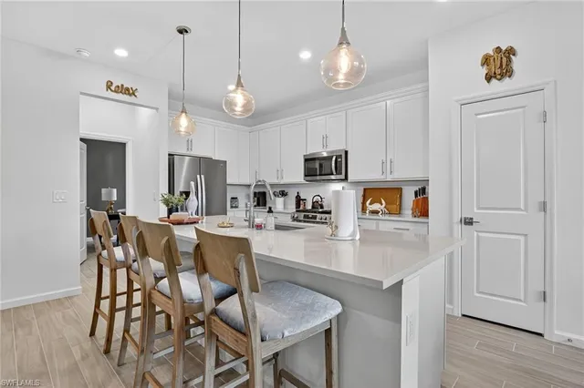 a living room with furniture and kitchen view