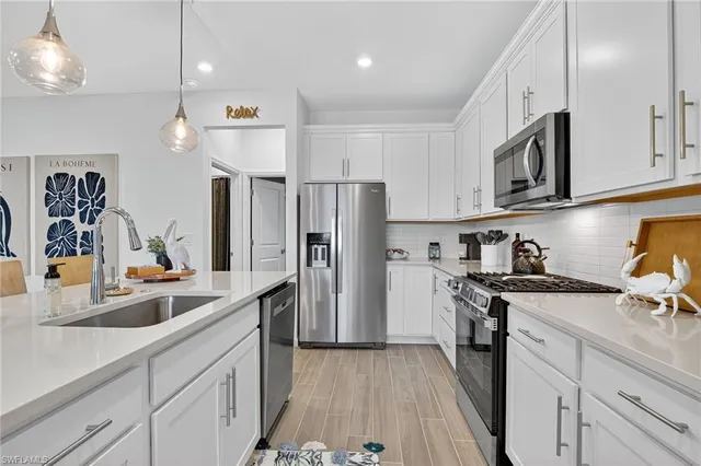 a living room with furniture and kitchen view