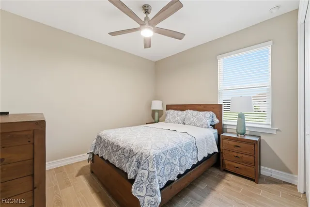 a bedroom with a bed and a ceiling fan