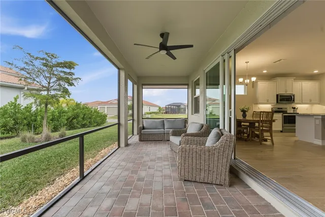 a living room with furniture and a floor to ceiling window
