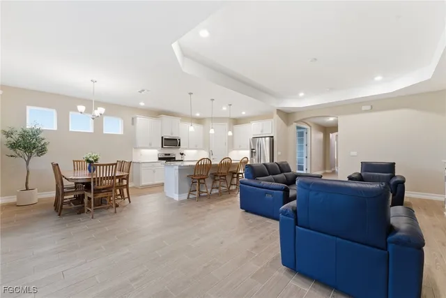 a living room with furniture and kitchen view
