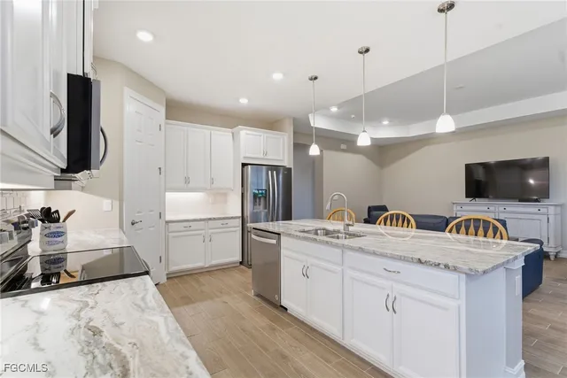 a kitchen with a sink stove and refrigerator