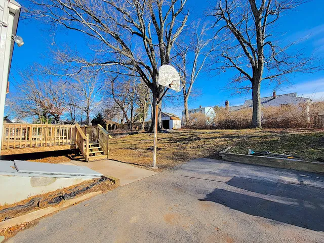a view of a yard with wooden fence