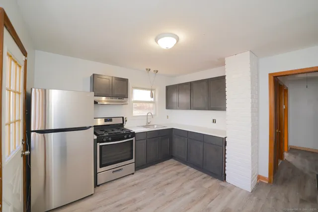 a kitchen with a refrigerator and a sink