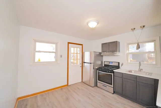 a kitchen with a refrigerator stove and sink
