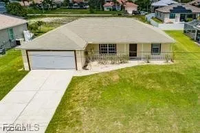 a front view of a house with swimming pool and yard