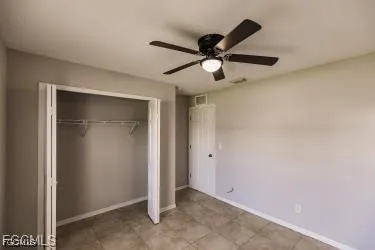 a kitchen with granite countertop a sink a stove a refrigerator a counter top space and cabinets