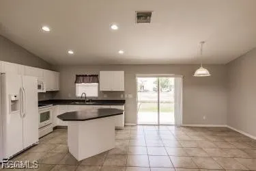 a kitchen with a stove a refrigerator and a sink