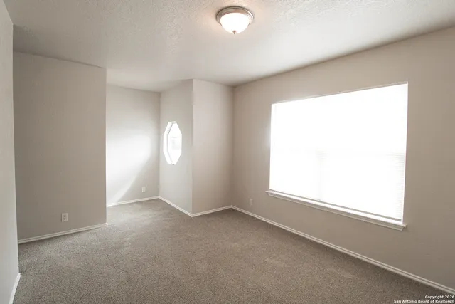 an empty room with windows and closet