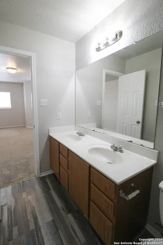 a bathroom with a sink vanity granite and a mirror