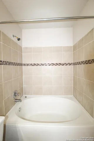 a bathroom with a shower and a bathtub