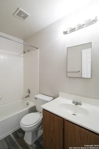 a bathroom with a sink toilet vanity and shower