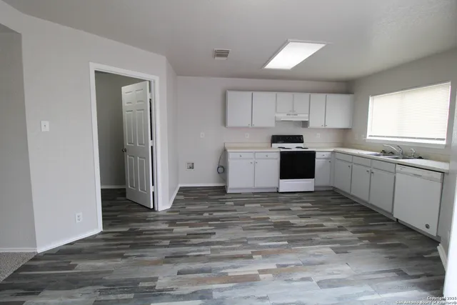 a view of kitchen with wooden floor and window
