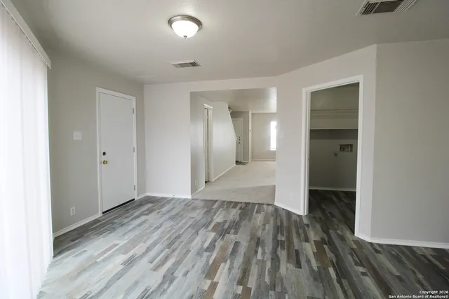 a view of hallway with wooden floor