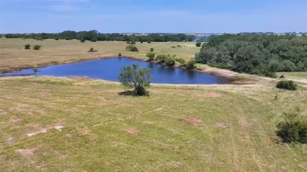 a view of a lake with houses in the back