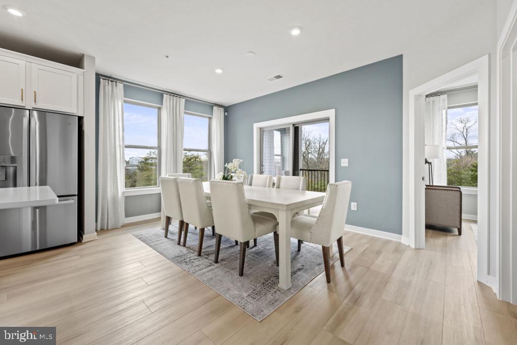 13628 Innovation Station Loop Herndon, VA 20171 - Photo 13 of 38 a view of a dining room with furniture and wooden floor