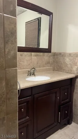 a bathroom with a sink vanity and mirror