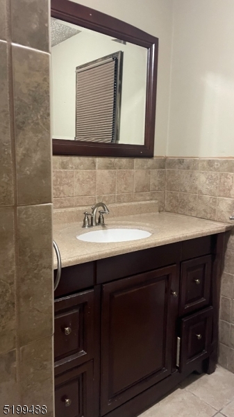 a bathroom with a sink vanity and mirror
