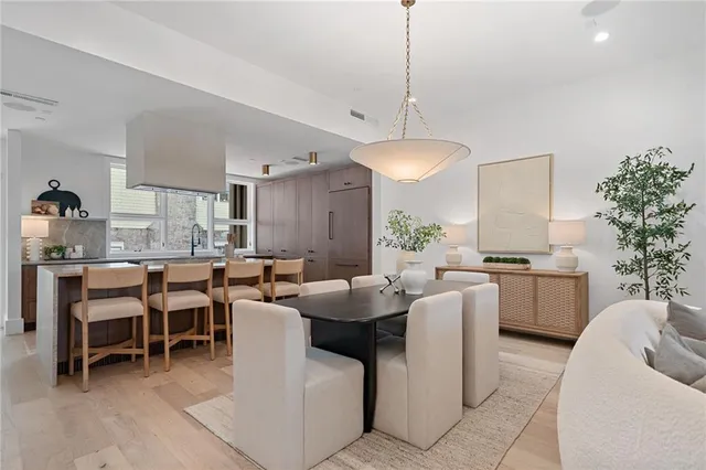 a living room with furniture a chandelier fan and a window