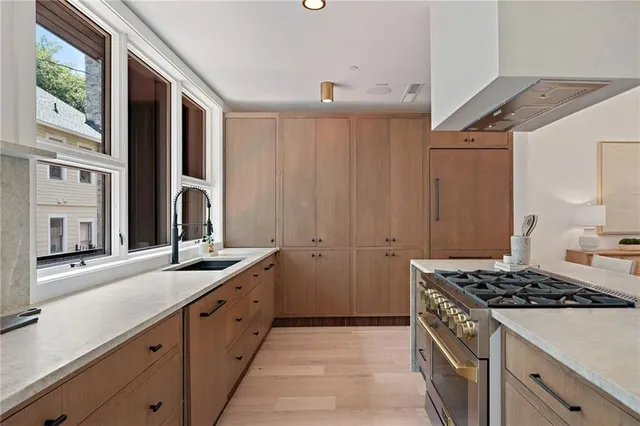 a living room with a mirror and a potted plant