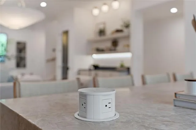 a bedroom with a bed next to a window and a flat tv screen