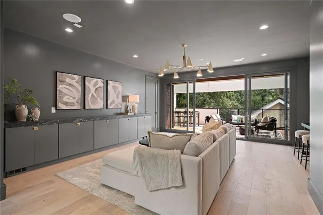 a living room with furniture and a floor to ceiling window