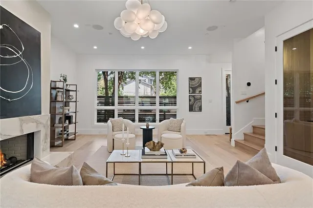 a living room with furniture a large window and a fireplace