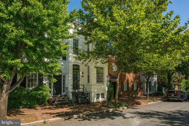 a front view of a building with trees