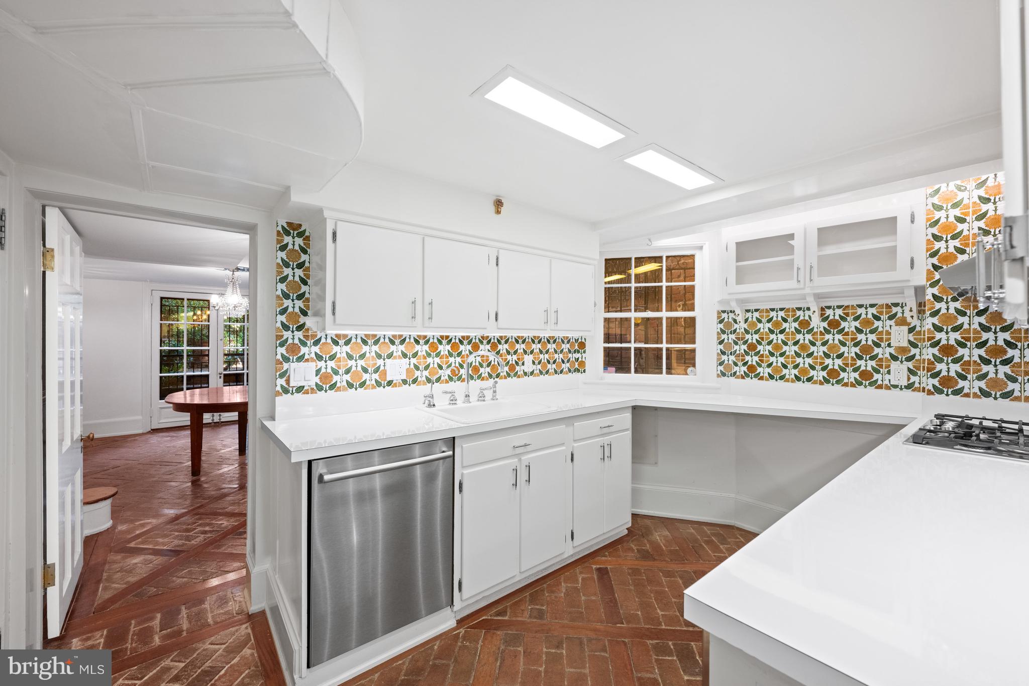 1423 34th Street Northwest Washington, DC 20007 - Photo 21 of 30 a kitchen with a sink a table and chairs