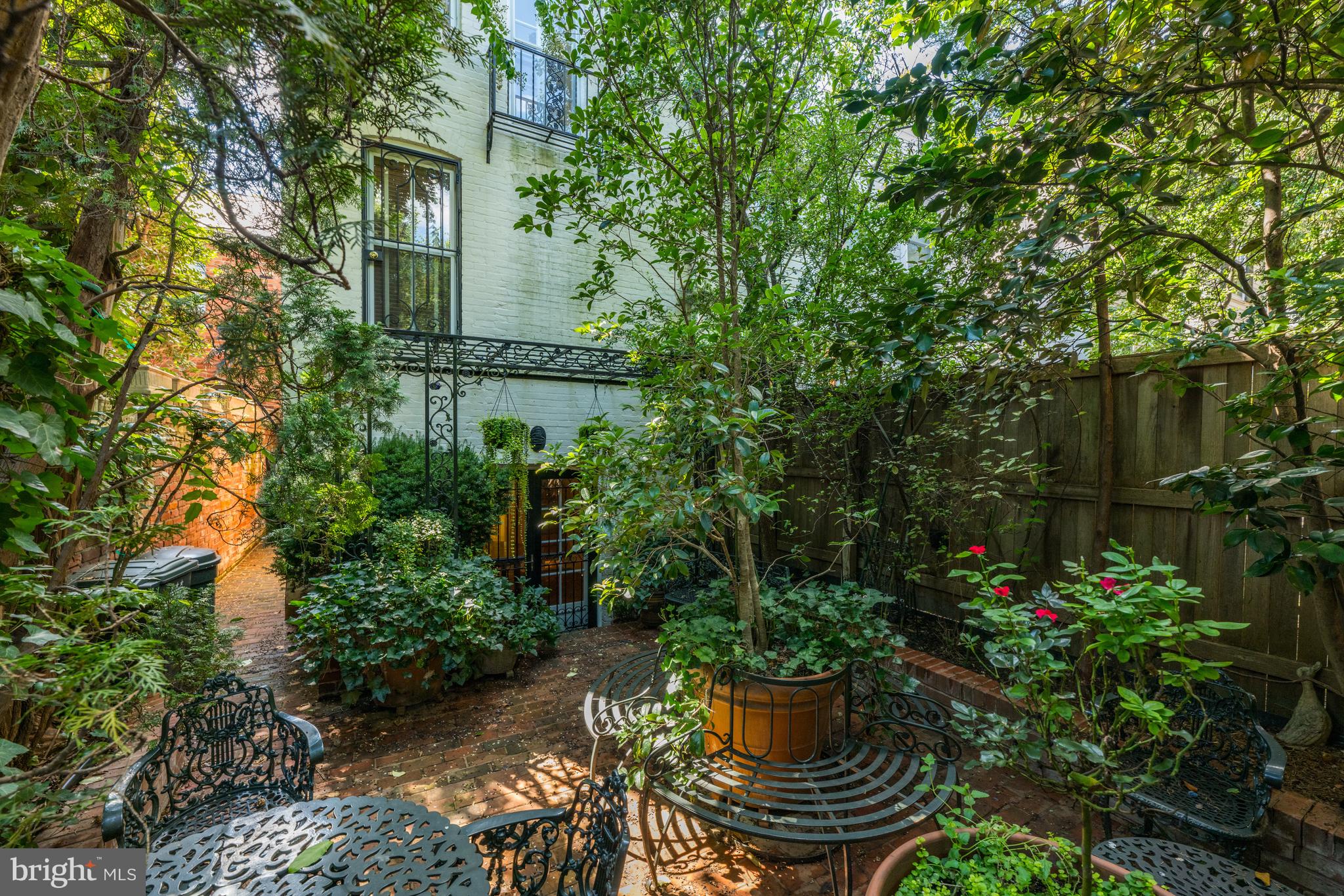 1423 34th Street Northwest Washington, DC 20007 - Photo 26 of 30 a view of a garden with plants and a bench