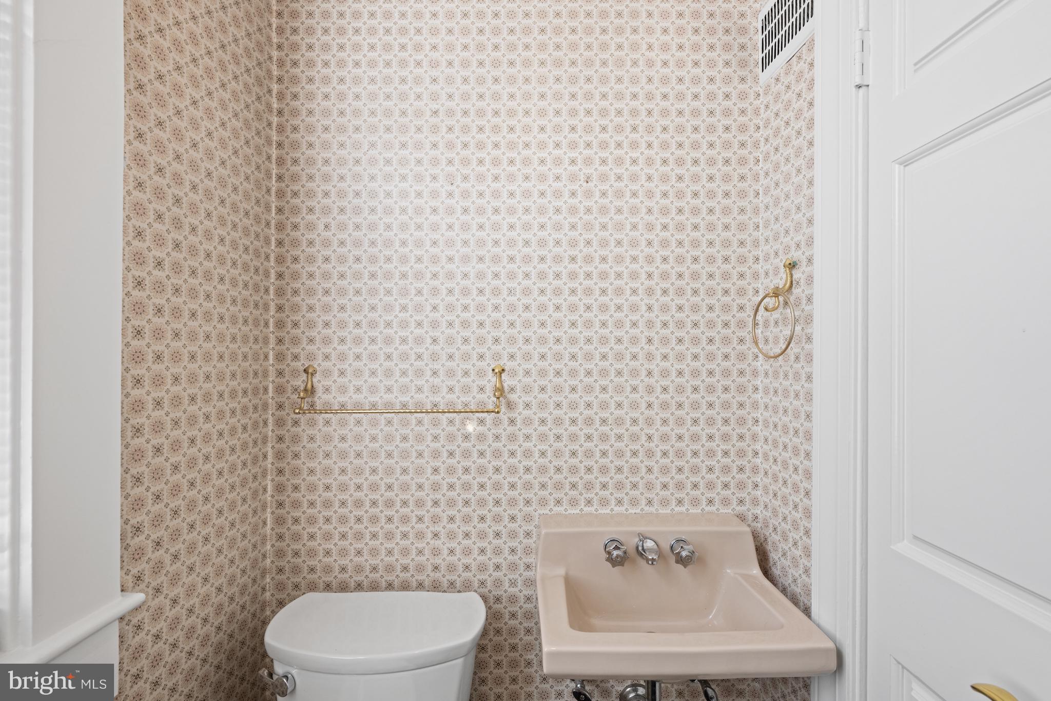 1423 34th Street Northwest Washington, DC 20007 - Photo 8 of 30 a white toilet sitting next to a white wall