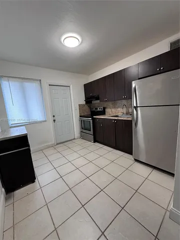 a kitchen with stainless steel appliances a refrigerator and a stove top oven