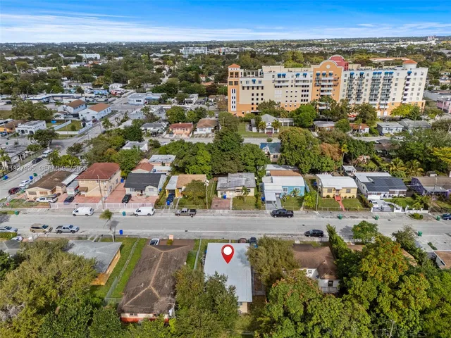 an aerial view of residential houses with outdoor space