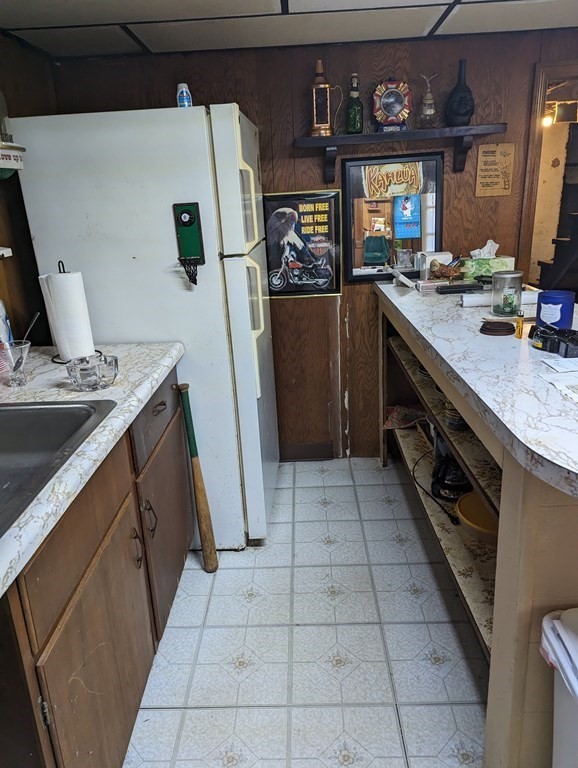34 Colonial Road Sutton, MA 01590 - Photo 19 of 34 a kitchen with a sink a refrigerator and washer