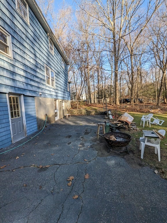 34 Colonial Road Sutton, MA 01590 - Photo 24 of 34 a view of a backyard with table and chairs and a barbeque