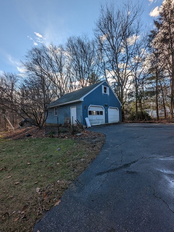 34 Colonial Road Sutton, MA 01590 - Photo 25 of 34 a house view with wooden fence and trees