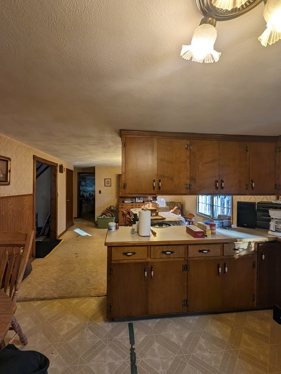 34 Colonial Road Sutton, MA 01590 - Photo 4 of 34 a kitchen with a sink a stove and cabinets