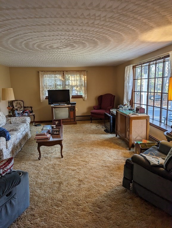 34 Colonial Road Sutton, MA 01590 - Photo 6 of 34 a living room with furniture window and a table