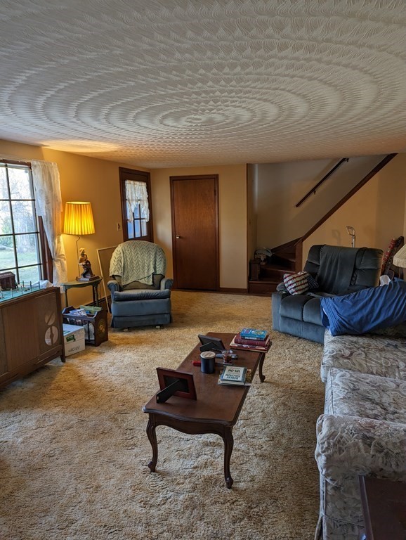 34 Colonial Road Sutton, MA 01590 - Photo 7 of 34 a living room with furniture and a couch