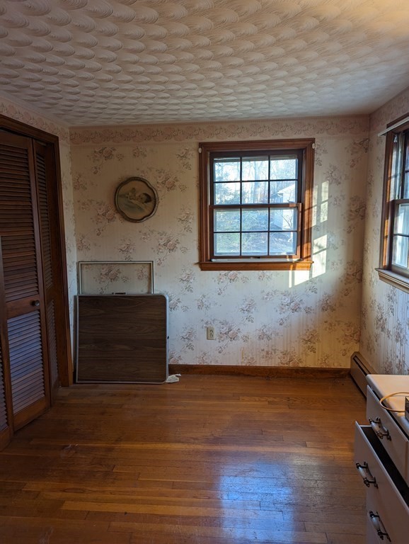 34 Colonial Road Sutton, MA 01590 - Photo 9 of 34 a view of an empty room with a window and wooden floor