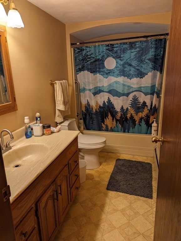 34 Colonial Road Sutton, MA 01590 - Photo 10 of 34 a bathroom with a sink mirror and vanity