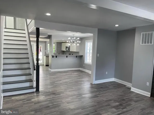 a view of kitchen with refrigerator and window