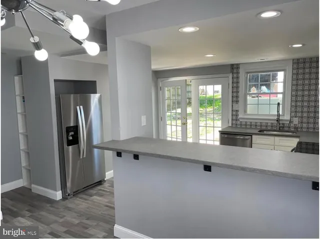 a kitchen with white cabinets stainless steel appliances and sink