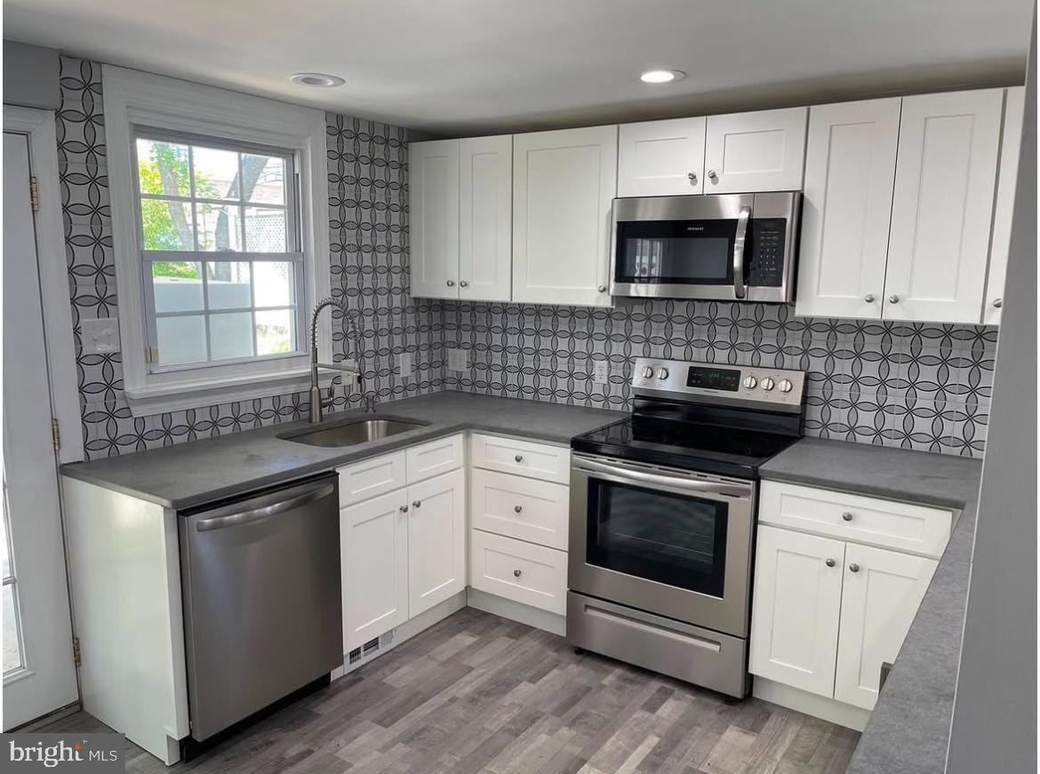 425 Main Street Royersford, PA 19468 - Photo 4 of 17 a kitchen with white cabinets stainless steel appliances and sink
