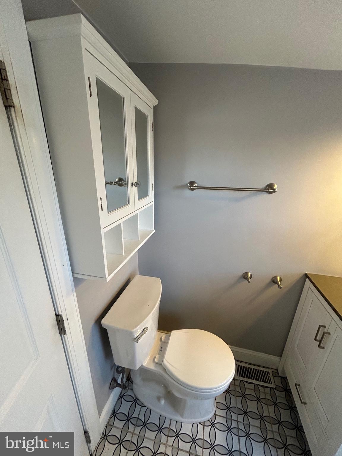 425 Main Street Royersford, PA 19468 - Photo 8 of 17 a white toilet sitting next to a bathroom sink and a mirror