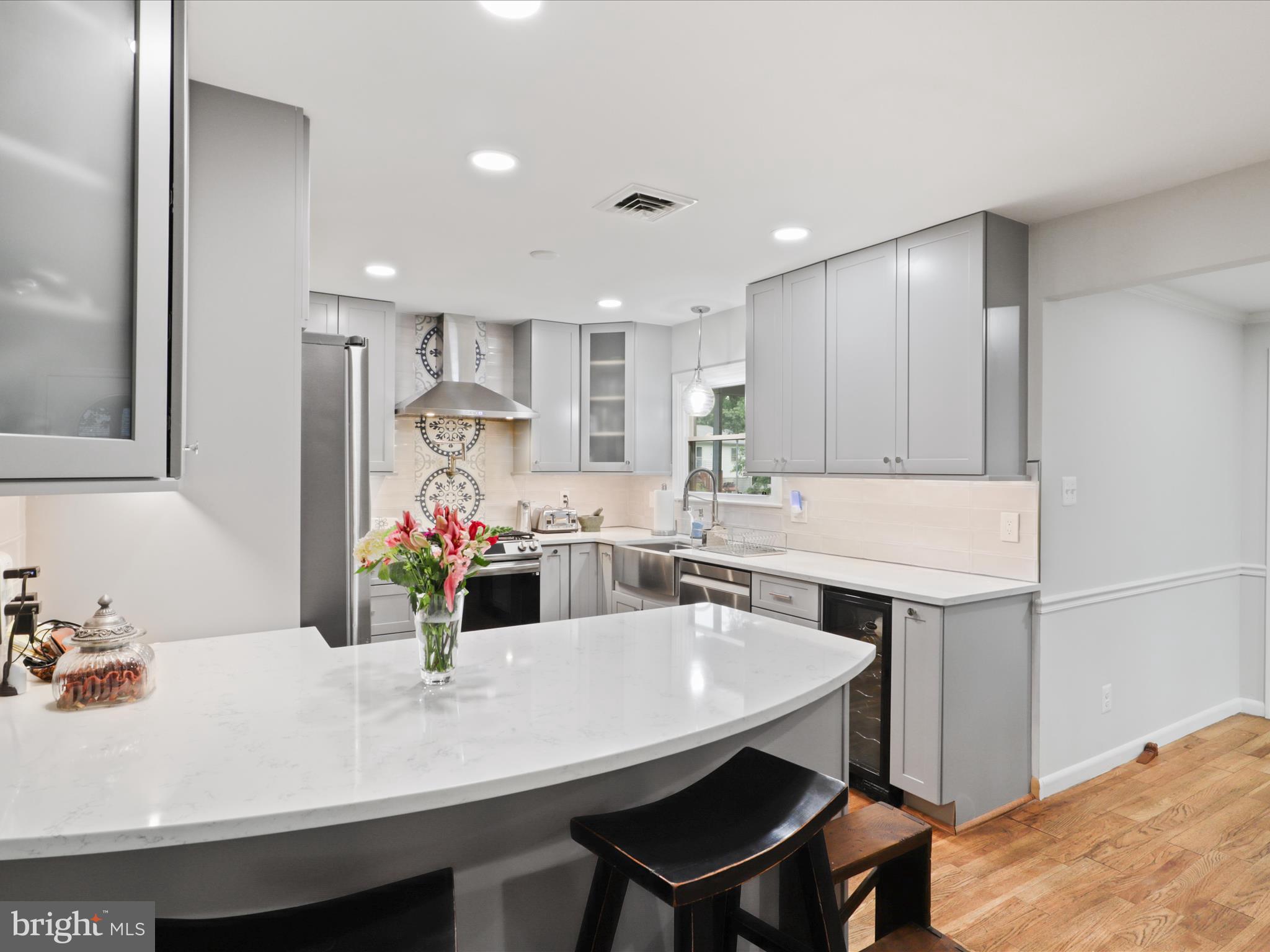 800 Williamsburg Road Sterling, VA 20164 - Photo 19 of 46 a kitchen with kitchen island a stove a table and chairs in it